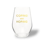 Clear stemless wine glass with gold foil text reading 