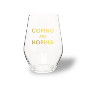 Clear stemless wine glass with gold foil text reading "COPING AND HOPING", perfect for dining and entertaining, featured by Knotty and Board in curated decor and gifts.