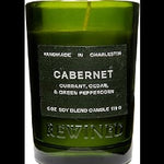 Rewined Candle 6oz Cabernet in a green glass container with black label, featuring scents of currant, cedar, and green peppercorn, ideal for decor and gifts from Knotty and Board. 1