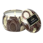 Voluspa Forbidden Fig Mini Tin Candle, 4 oz, showing an open floral-patterned tin with a lit candle inside, available at Knotty and Board, perfect for home decor and gifts. 1