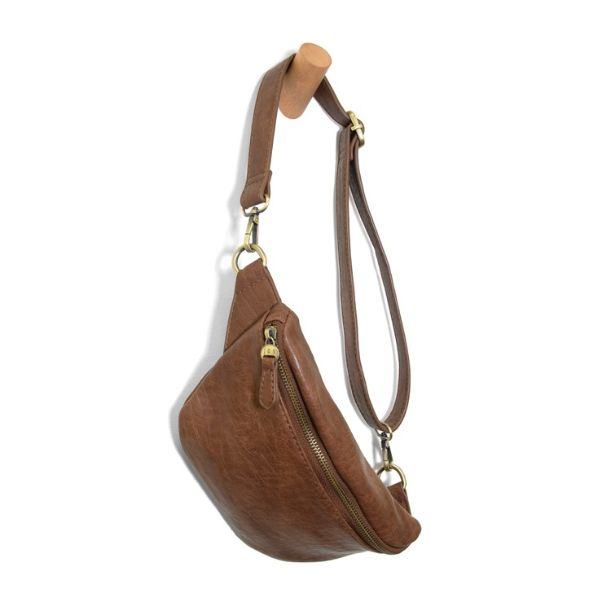 Shiloh Sling Belt Bag, Saddle in warm brown leather with adjustable strap and brass hardware, styled for everyday use with Knotty and Board's curated gifts and decor.