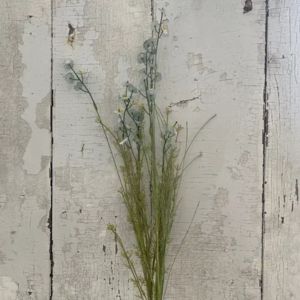 Wildflower Spray, 24 in., Maya displayed against a rustic white wooden background, highlighting delicate green stems and small blue flowers for natural home decor.