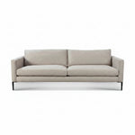 A modern two-seater sofa upholstered in a light beige textured fabric, featuring slim black metal legs, shown against a plain white background. 1