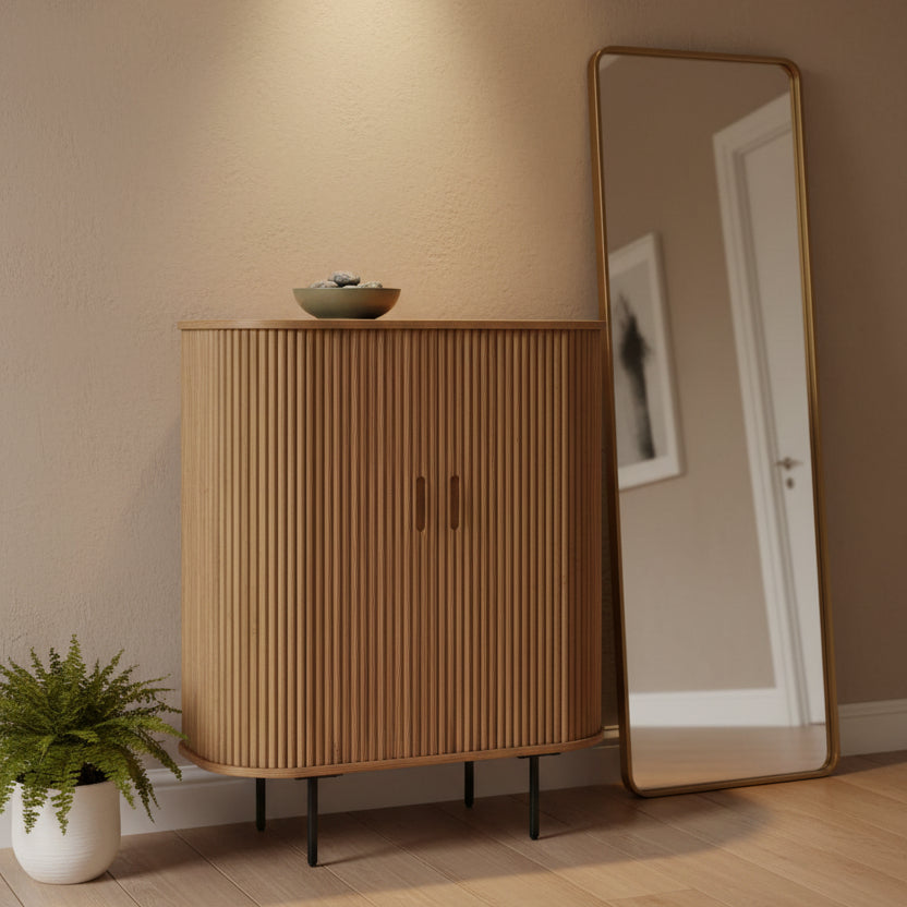 A mid-century modern bamboo cabinet with a curved front, vertical slatted bamboo doors, and thin black metal legs, shown against a plain white background.