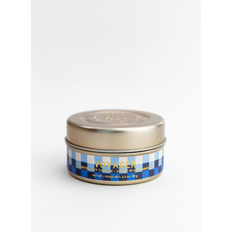 Small tin candle with gold lid and blue checkered label reading Mer-Sea Voyager Tin Candle, ideal for kitchen or dining decor and gifts from Knotty and Board.