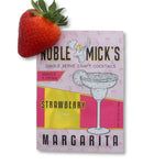 Noble Mick's Single Serve Craft Cocktail, Strawberry Margarita packaging next to a fresh strawberry, perfect for gifts and entertaining from Knotty and Board. 1