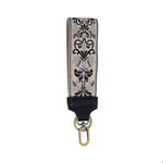 Easy Find Wristlet, Grey Floral Filigree Embroidered with an elegant grey and black embroidered design and a gold-tone clasp, perfect for stylish organization from Knotty and Board. Every Room Needs A Little Knotty and Board. 1