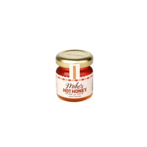 Small glass jar of Mike's Hot Honey Mini Jars, Original, 1.55 oz with golden lid, perfect for kitchen gifts and dining at Knotty and Board, Every Room Needs A Little Knotty and Board.