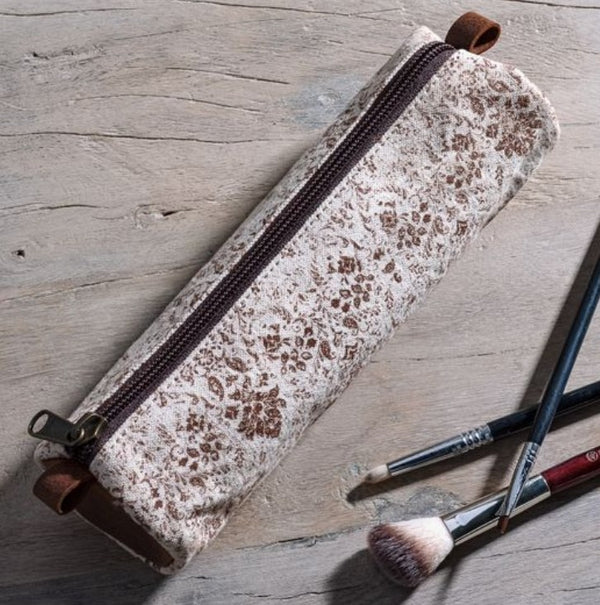 Brown Fleur Canvas Pencil Case 8.5" with brown floral pattern on canvas fabric, shown with makeup brushes on a rustic wood surface, perfect for stylish decor and gifts.