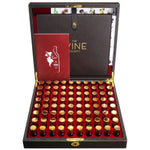 Luxury wooden display case open to reveal multiple small glass vials with golden caps and a booklet, showcasing the Wine Aroma Kit 80-Fragrance Training Kit For Wine Sommelier, a perfect gift from Knotty and Board for wine enthusiasts and decor lovers. 1
