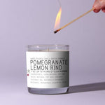Hand lighting a Just Bee Pomegranate & Lemon Rind Candle - 7 oz with natural soy wax and essential oils, ideal for kitchen and entertaining decor from Knotty and Board. 2