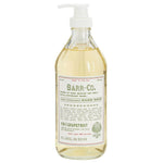 Clear pump bottle of Barr Co 16 oz Hand Soap, Fir/Grapefruit with natural pale yellow liquid inside, featuring a rustic label and perfect for kitchen or bathroom decor by Knotty and Board. 1