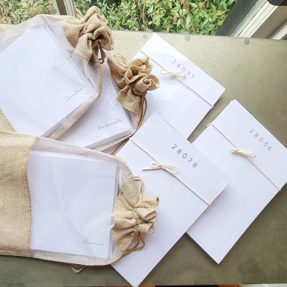 Note Card Set Pack of 10 - Cornelius with elegant white cards tied with string, displayed alongside burlap drawstring pouches, ideal for stylish gifts and decor from Knotty and Board.