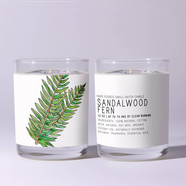 Just Bee Sandalwood Fern Candle, 7 oz. displayed in clear glass with a green fern illustration and natural cotton wick, perfect for decor, gifts, and cozy ambiance from Knotty and Board.