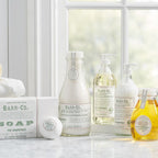 Range of Barr Co 16 oz Hand Soap, Fir/Grapefruit and complementary bath products displayed on marble countertop near window, styled for decor and gifts by Knotty and Board.