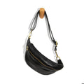 Shiloh Sling Belt Bag, Black hanging on a wooden peg, featuring a sleek black leather design with gold-tone zipper and adjustable strap, perfect for stylish everyday use.