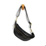 Shiloh Sling Belt Bag, Black hanging on a wooden peg, featuring a sleek black leather design with gold-tone zipper and adjustable strap, perfect for stylish everyday use. 1