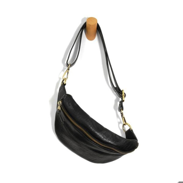 Shiloh Sling Belt Bag, Black hanging on a wooden peg, featuring a sleek black leather design with gold-tone zipper and adjustable strap, perfect for stylish everyday use.
