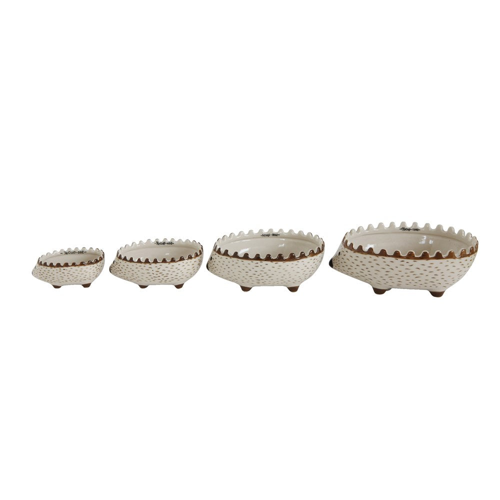 Set of four hand-painted hedgehog measuring cups with textured details and brown accents, perfect for kitchen decor and unique gifts, offered by Knotty and Board.