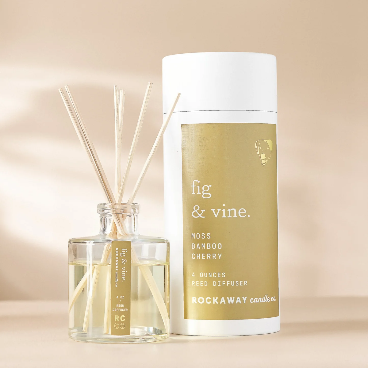 Rockaway Fig & Vine Reed Diffuser with bamboo reeds and glass bottle next to white and gold packaging, ideal for stylish home decor and thoughtful gifts from Knotty and Board.