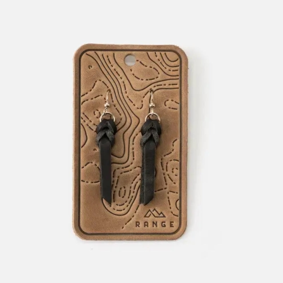 Braided Earrings, Black displayed on a textured tan card with contour lines, showcasing a simple and stylish accessory perfect for gifting or adding to jewelry collections.