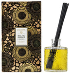 Voluspa Baltic Amber Reed Diffuser, 3.4 fl oz with textured glass bottle and black floral decorative packaging, an elegant home decor gift from Knotty and Board. 1