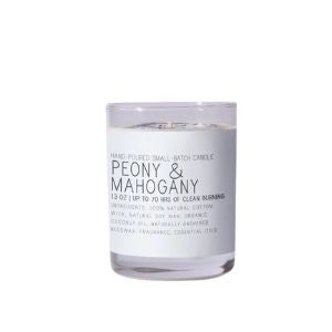 Just Bee Peony & Mahogany Candle, 13 oz in a clear glass container with a white label showcasing the scent, perfect for adding warm decor and inviting fragrance to any room, from Knotty and Board. Every Room Needs A Little Knotty and Board.
