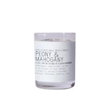 Just Bee Peony & Mahogany Candle, 13 oz in a clear glass container with a white label showcasing the scent, perfect for adding warm decor and inviting fragrance to any room, from Knotty and Board. Every Room Needs A Little Knotty and Board. 1