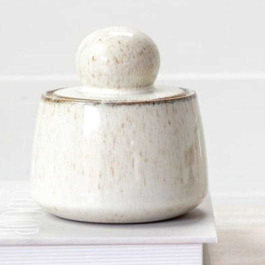 Stash Pot 4.9" ceramic container with a rounded lid, featuring a speckled off-white glaze, perfect for stylish kitchen or home decor from Knotty and Board.