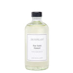 Clear glass bottle of Archipelago Rue Saint Honore Diffuser Oil Refill, 7.8 oz, with black cap and minimalist white label, elegant home decor gift solution from Knotty and Board. 1